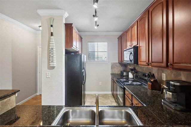 kitchen with dark stone countertops, a sink, crown molding, black appliances, and backsplash