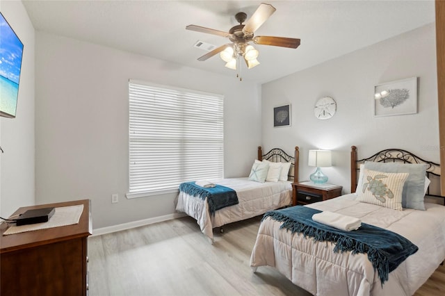 bedroom with multiple windows, light wood-type flooring, and ceiling fan