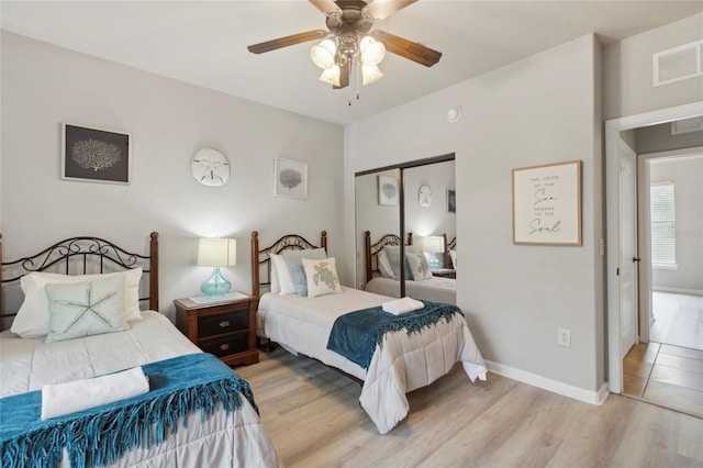 bedroom featuring a closet, ceiling fan, and light wood-type flooring