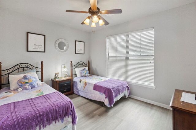 bedroom with light hardwood / wood-style flooring and ceiling fan