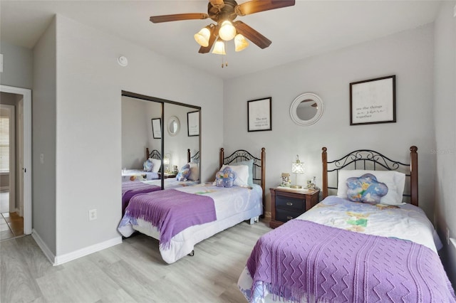 bedroom with light hardwood / wood-style flooring, a closet, and ceiling fan