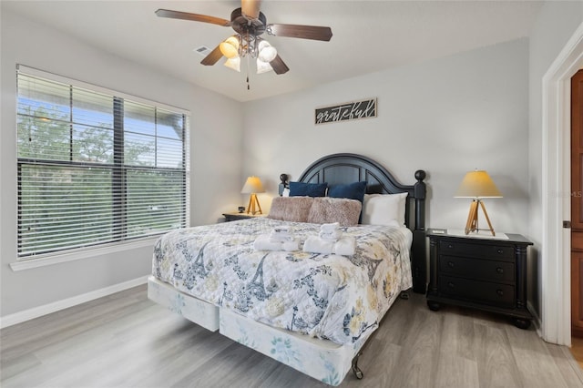 bedroom featuring ceiling fan and light hardwood / wood-style flooring