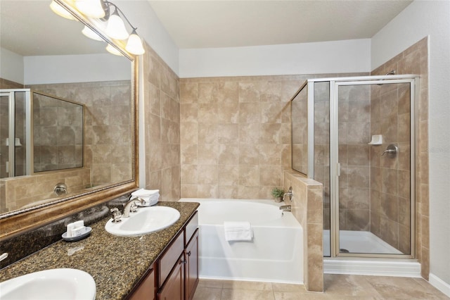 bathroom featuring double vanity, plus walk in shower, and tile patterned floors