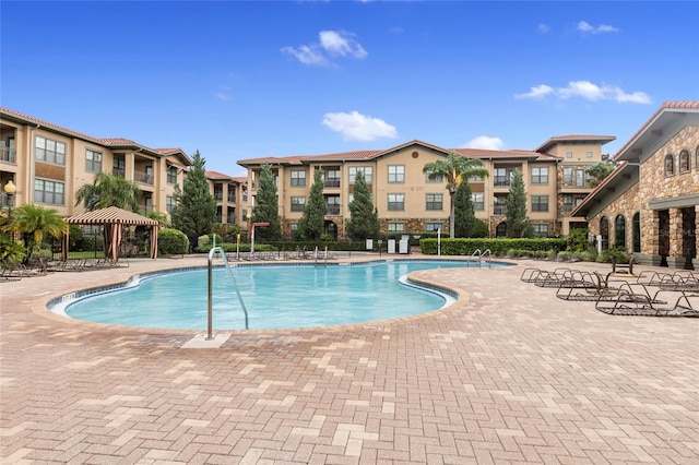 view of swimming pool with a patio and a gazebo