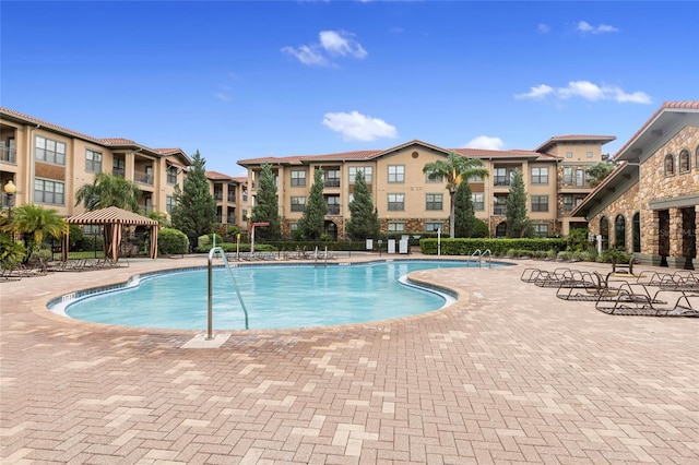 pool with a gazebo and a patio area