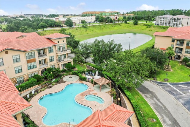 view of pool with a patio, a water view, and a community hot tub