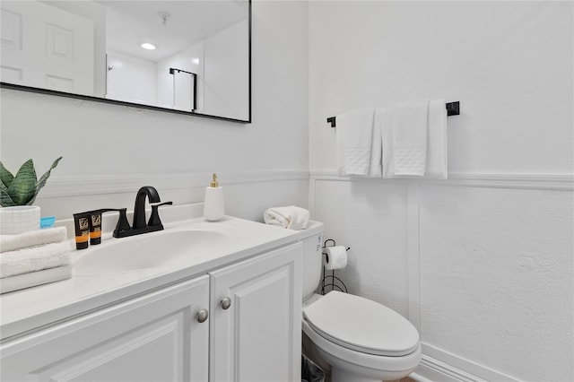 bathroom featuring toilet and vanity