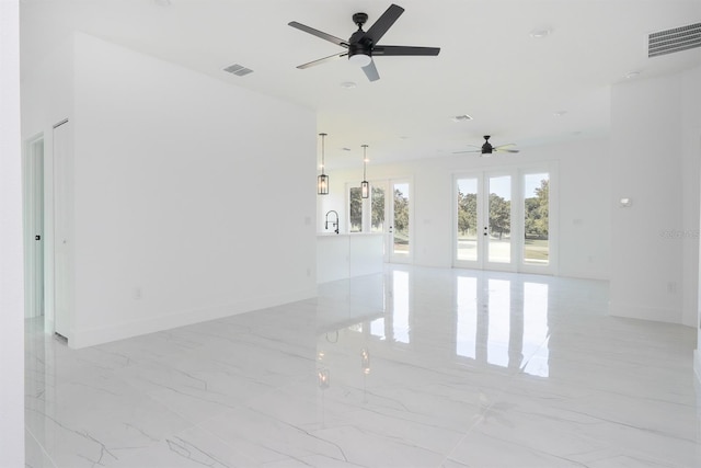 unfurnished room with ceiling fan, light tile patterned flooring, and french doors