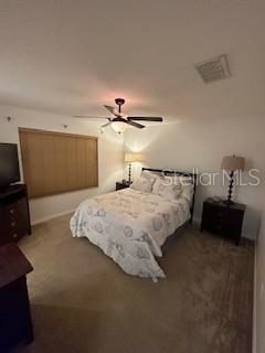 bedroom with dark carpet and ceiling fan