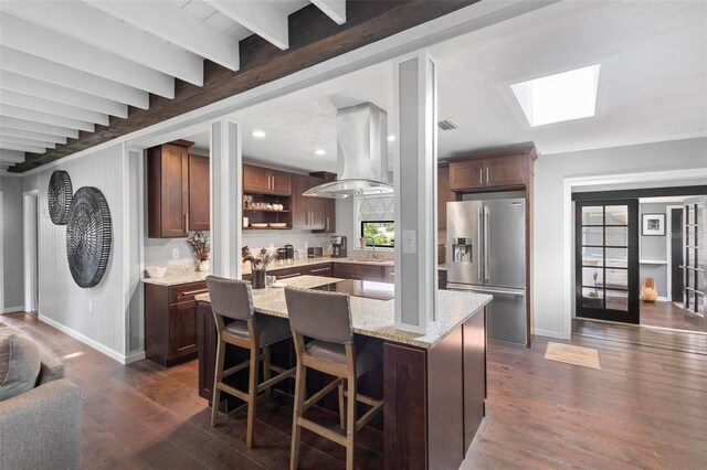 kitchen with stainless steel fridge with ice dispenser, island exhaust hood, beamed ceiling, a center island, and dark hardwood / wood-style floors