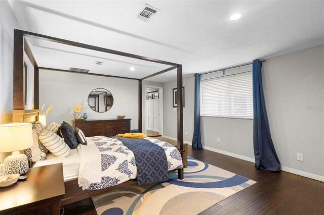 bedroom with dark wood-type flooring