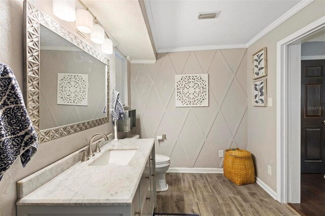 bathroom with vanity, tile walls, wood-type flooring, and crown molding