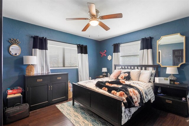 bedroom with ceiling fan and hardwood / wood-style flooring