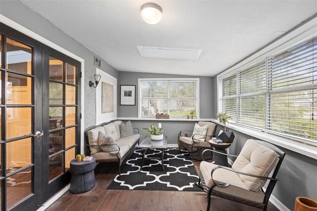 sunroom / solarium with a skylight and french doors