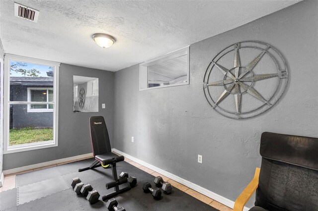 workout room with a textured ceiling