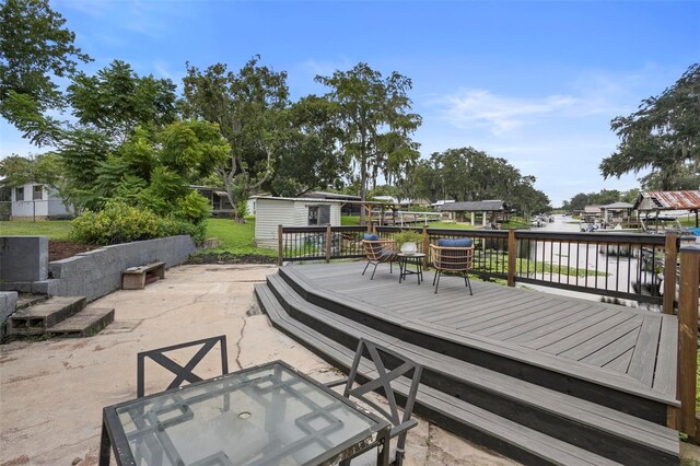 exterior space featuring a wooden deck and a patio