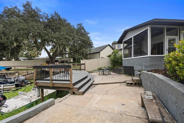 view of patio / terrace featuring a sunroom and a wooden deck