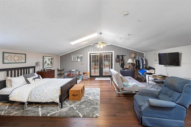 bedroom with french doors, wood walls, hardwood / wood-style flooring, vaulted ceiling, and access to exterior