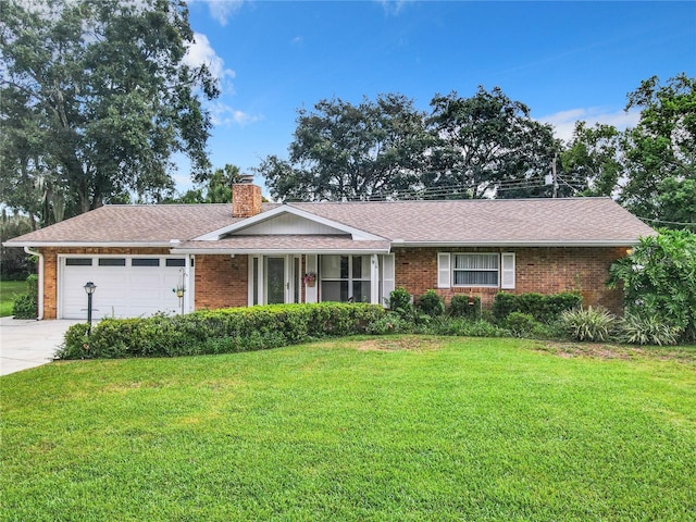 single story home with an attached garage, brick siding, concrete driveway, a front lawn, and a chimney