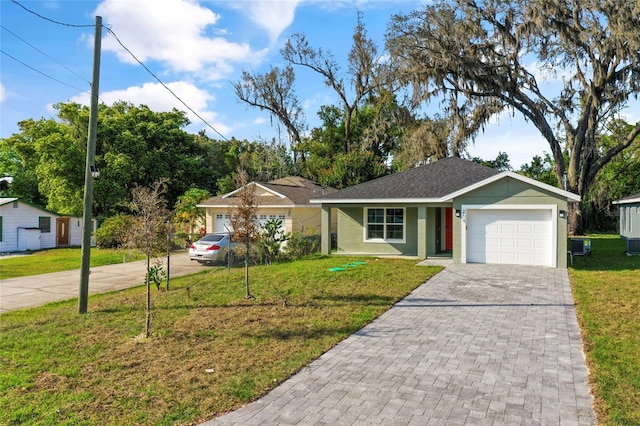 single story home with a garage and a front lawn