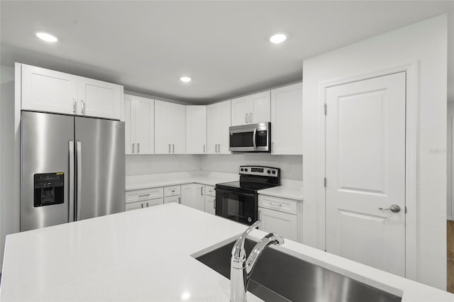 kitchen featuring white cabinets, appliances with stainless steel finishes, and sink