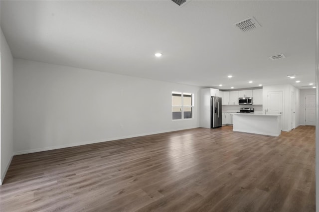 unfurnished living room with hardwood / wood-style floors