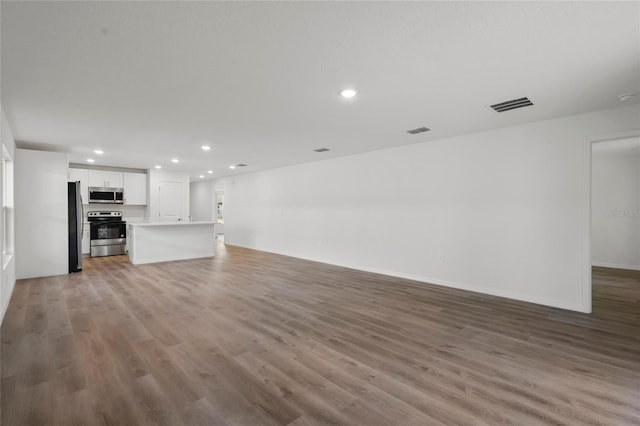 unfurnished living room with wood-type flooring