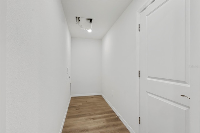 hallway with light hardwood / wood-style floors