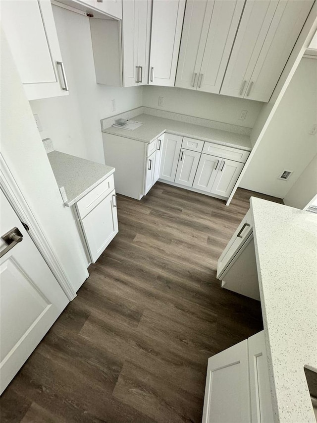 kitchen featuring dark hardwood / wood-style flooring and white cabinetry