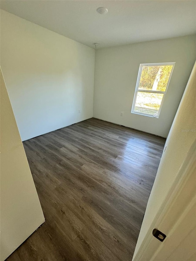 empty room with dark hardwood / wood-style floors