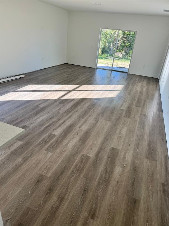 empty room featuring dark wood-type flooring