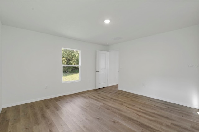 spare room with light wood-type flooring