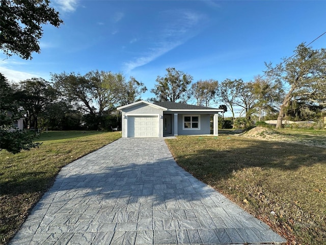 view of front of house with a garage, decorative driveway, a front lawn, and stucco siding