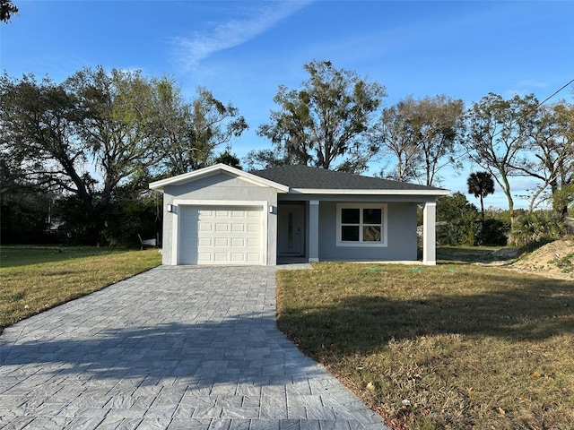 view of front facade featuring a front lawn, decorative driveway, an attached garage, and stucco siding