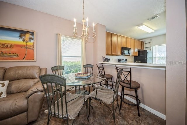 dining space featuring an inviting chandelier