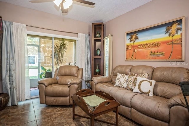 tiled living room with a textured ceiling and ceiling fan