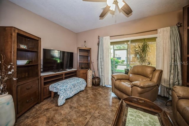 living room featuring tile patterned floors, a textured ceiling, and ceiling fan