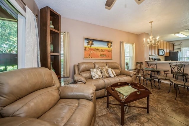 tiled living room with a wealth of natural light and a chandelier