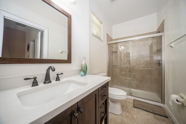 bathroom featuring vanity, an enclosed shower, tile patterned flooring, and toilet