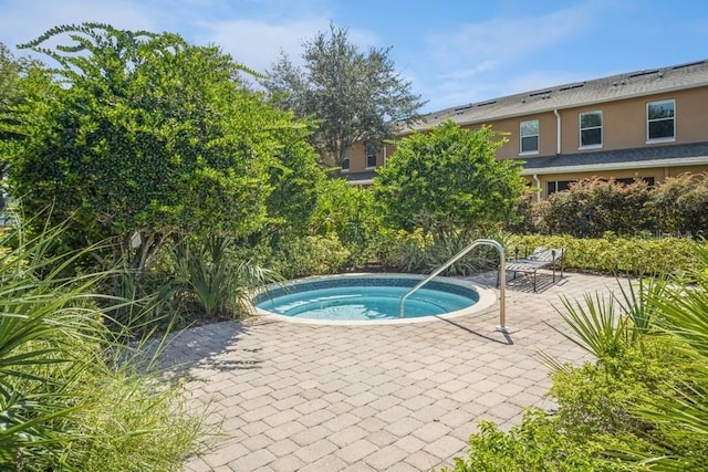 view of swimming pool with an in ground hot tub and a patio area