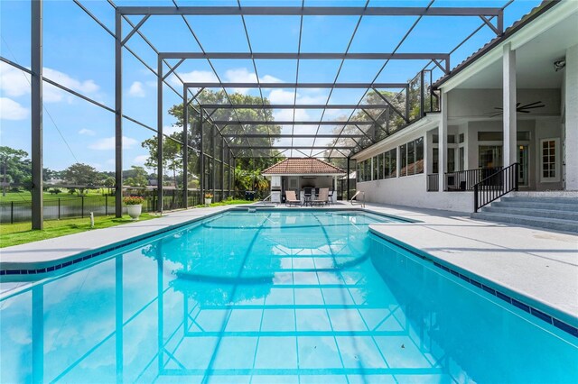 view of swimming pool with a gazebo, a lanai, ceiling fan, and a patio area