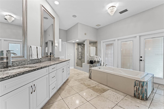 bathroom featuring vanity, french doors, and separate shower and tub