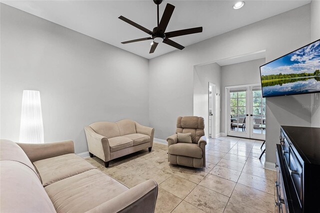 tiled living room with ceiling fan and french doors