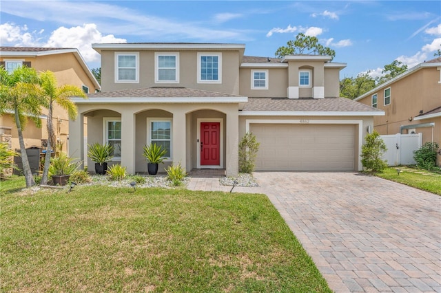 view of front of home with a garage and a front lawn