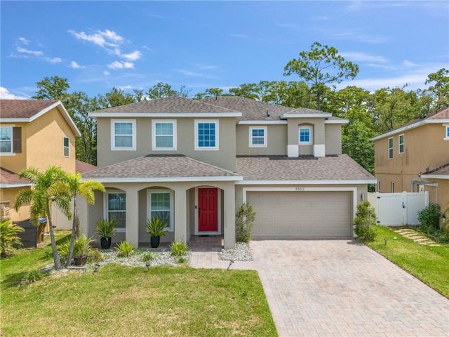 view of front of house with a garage and a front yard