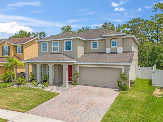 view of front of house with a garage and a front lawn