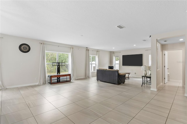 unfurnished living room featuring light tile patterned floors