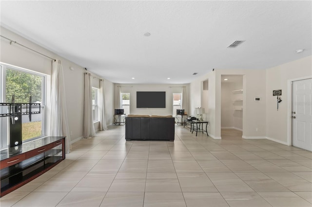 tiled living room with a wealth of natural light