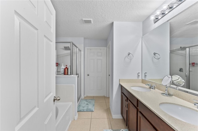 bathroom with independent shower and bath, tile patterned floors, a textured ceiling, and vanity