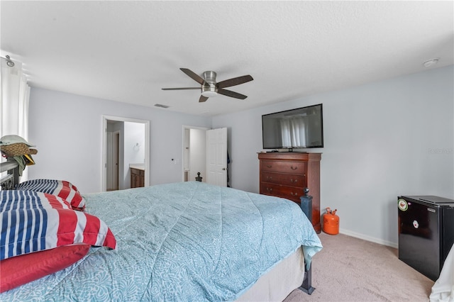 carpeted bedroom featuring ceiling fan and connected bathroom